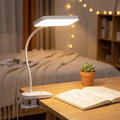 Aurora Clip-On LED Desk Lamp in a cozy bedroom study
